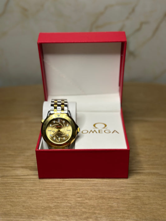 Omega Seamaster Diver AUTOMATICO fondo dorado bisel dorado pulsera metalica