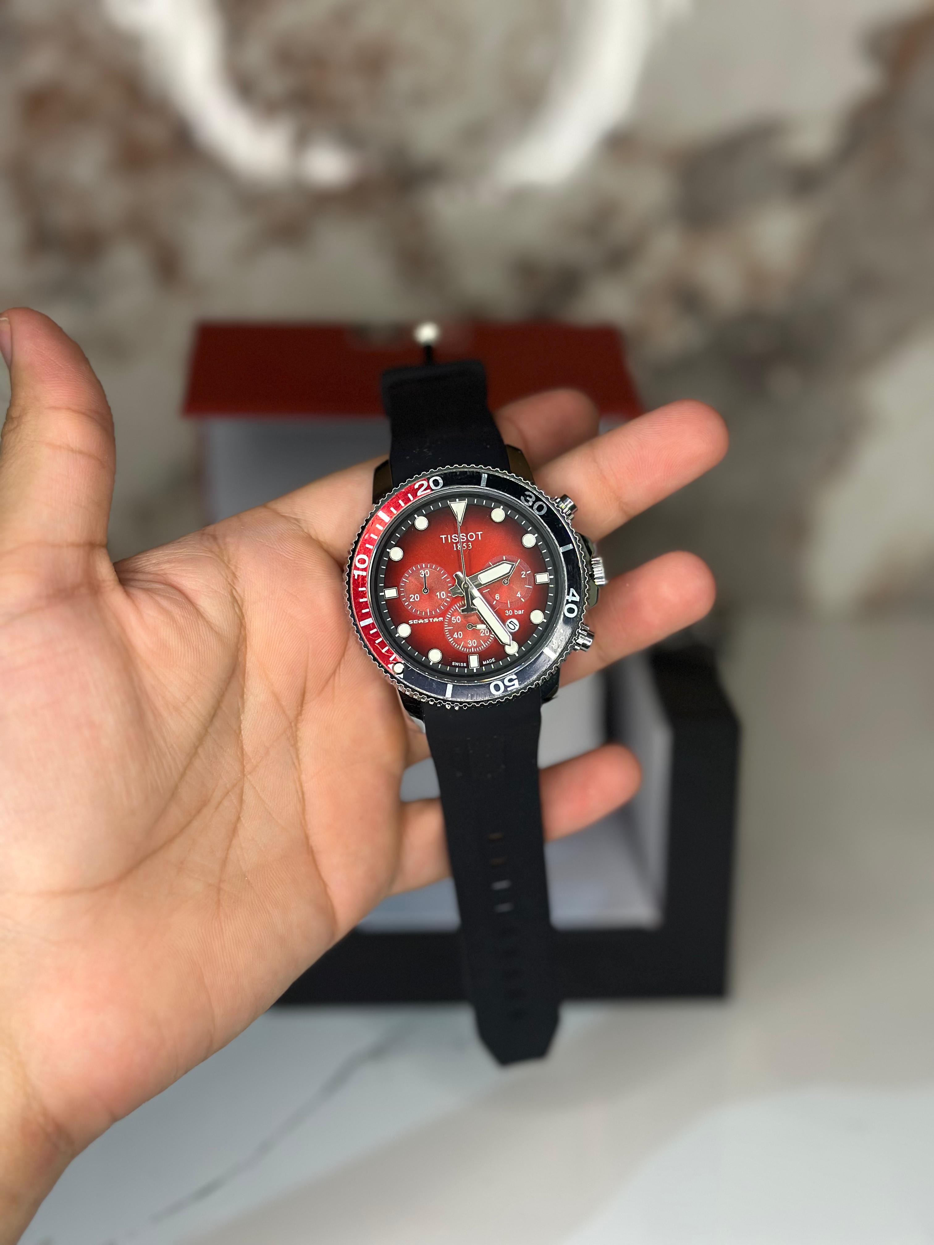 Reloj Tissot seastar 40mm correa de goma oscura fondo rojo